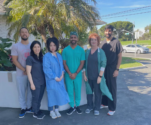 dr hirsh kaveeshvar and dr ashish shah with some of the local staff of synergexmed